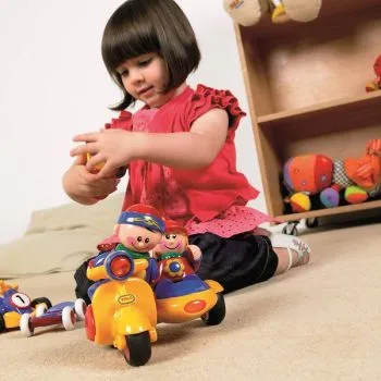 TOLO First Friends on wheels with happy playing girl TOLO First Friends on wheels with happy playing girl