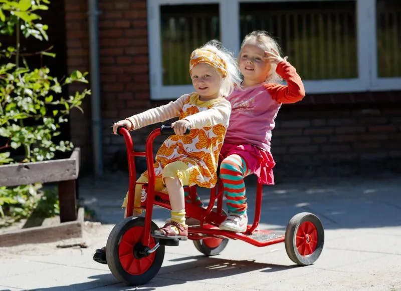 Winther taxi with happy playing children on the playground Winther taxi with happy playing children on the playground