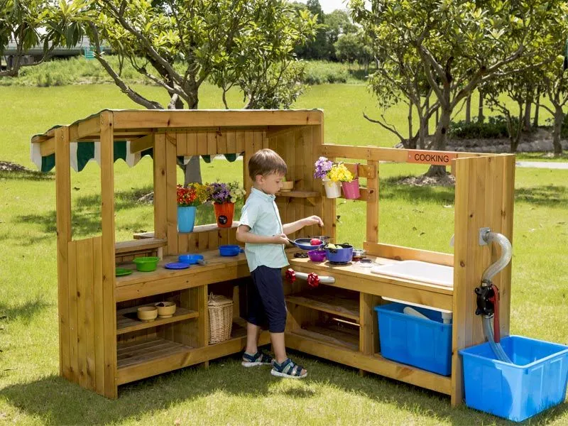 Outdoor children's kiosk with play kitchen backside with boy Outdoor children's kiosk with play kitchen backside with boy