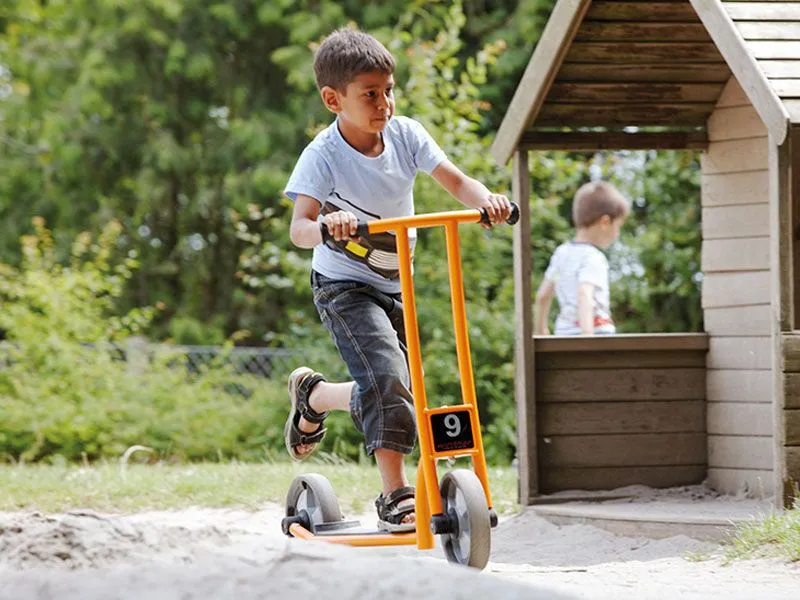 Scooter activ with happy boy on the playground Scooter activ with happy boy on the playground