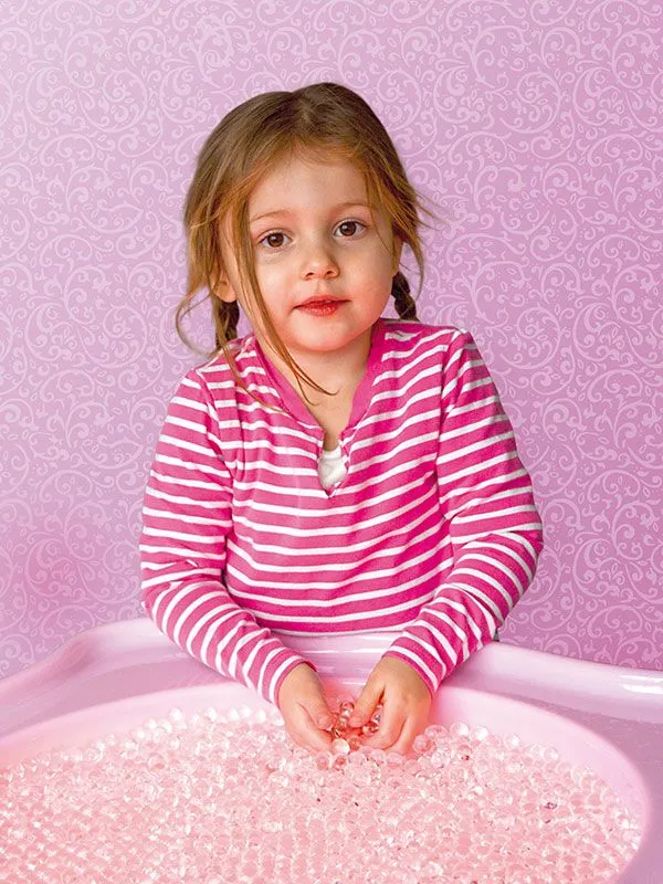 Water pearl sensor beads transparent in light table tub with child