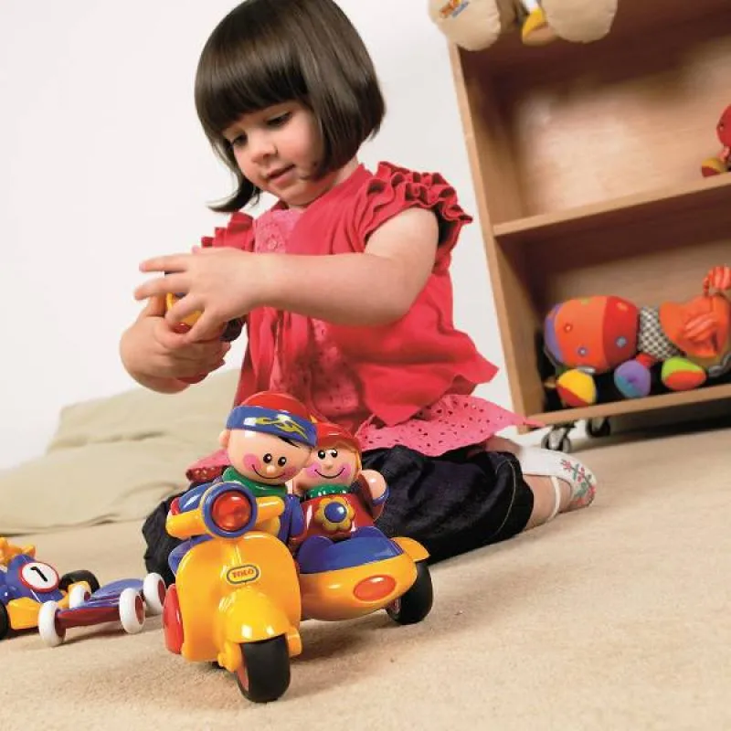 TOLO First Friends on wheels with happy playing girl TOLO First Friends on wheels with happy playing girl