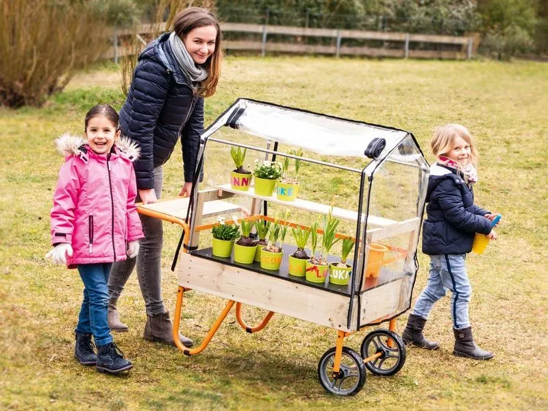Mobile greenhouse with children and educator during transport Mobile greenhouse with children and educator during transport