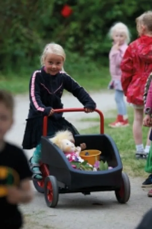 winther kangaroo trycycle with happy playing children on the playground winther kangaroo trycycle with happy playing children on the playground