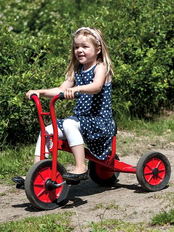 Tricycle medium by winther with happy girl Tricycle medium by winther with happy girl